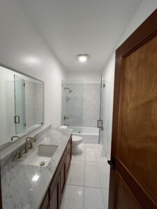 Guest Bathroom Bathtub Shower combo tile walls and floor