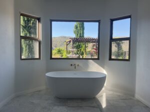 Bathroom with M=marble tile floor and stand alone bath tub